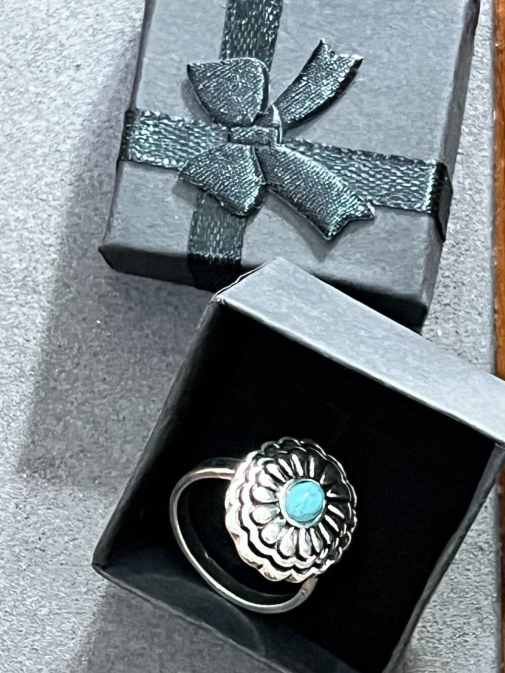 Silver-tone floral statement ring featuring an oval turquoise-color center stone